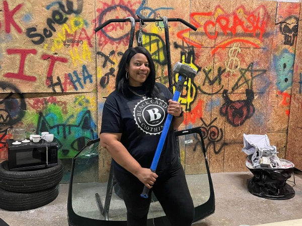 picture of woman with a hammer in a rage room